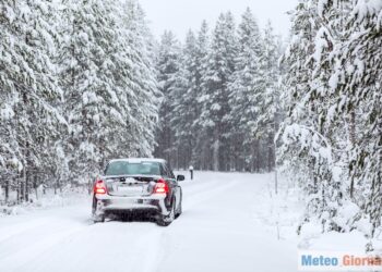 Land vehicle driving on a country road in wintry northern forest